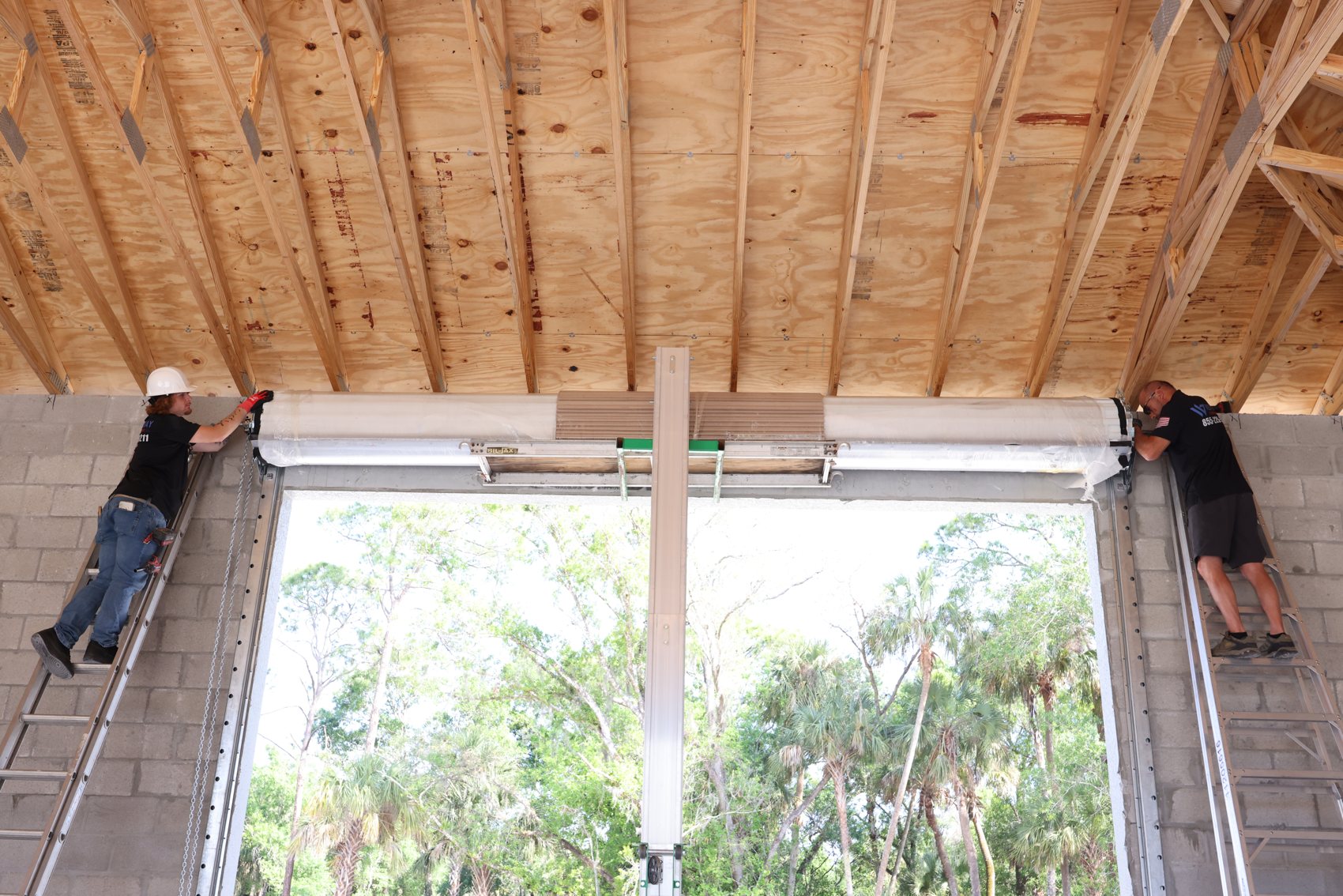 West Bay Garage Doors team installing a commercial overhead door in the Houston area